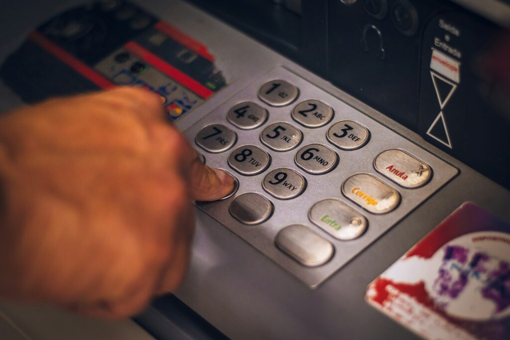 Member entering a PIN on an ATM keypad
